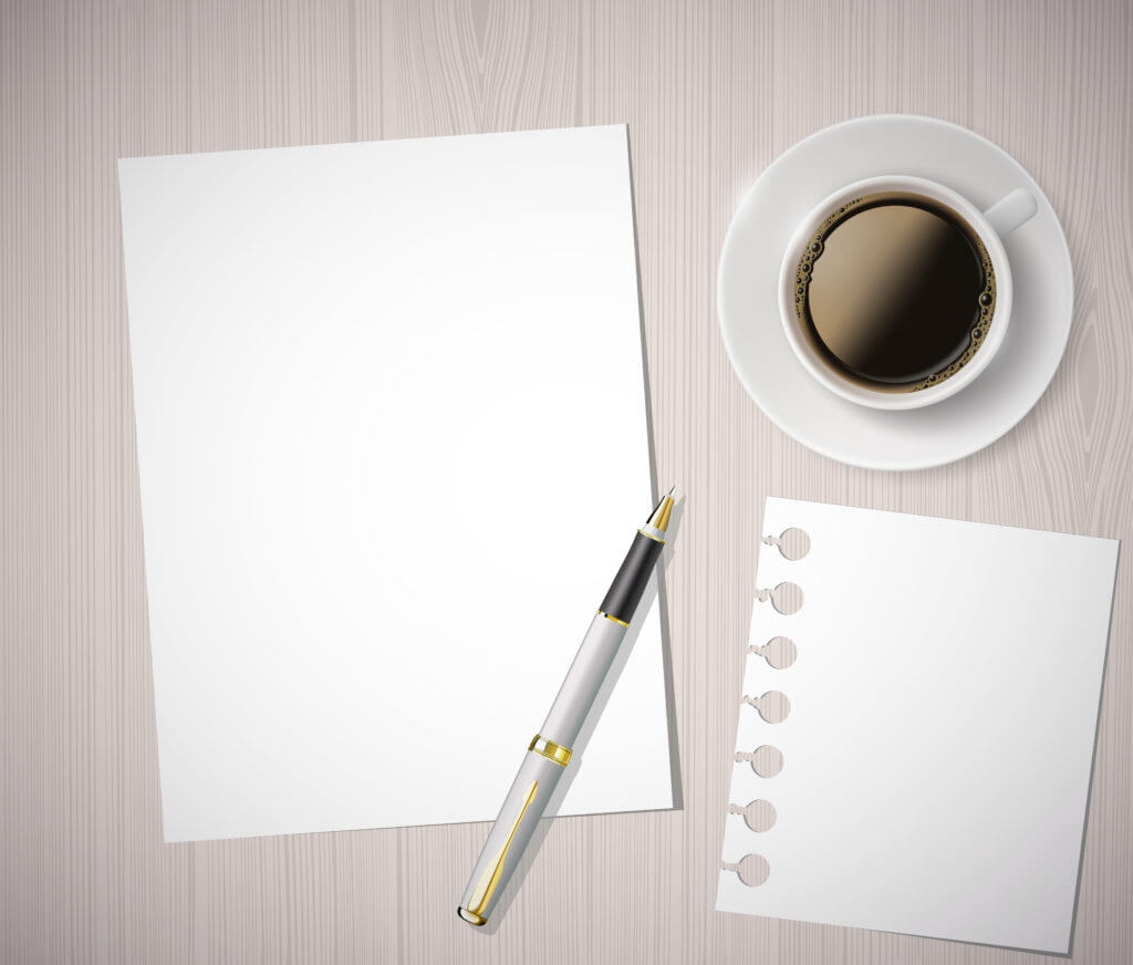 sheet of paper and a cup of coffee on a wooden table